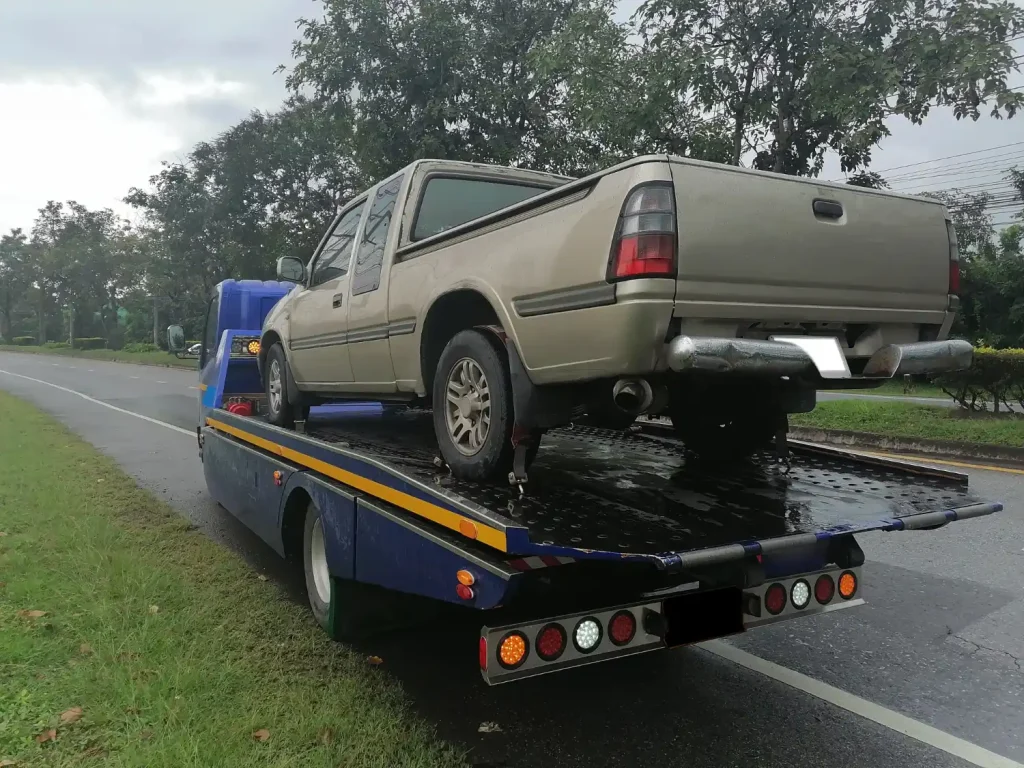 Accident vehicle recovery service transporting damaged cars to garage or secure storage